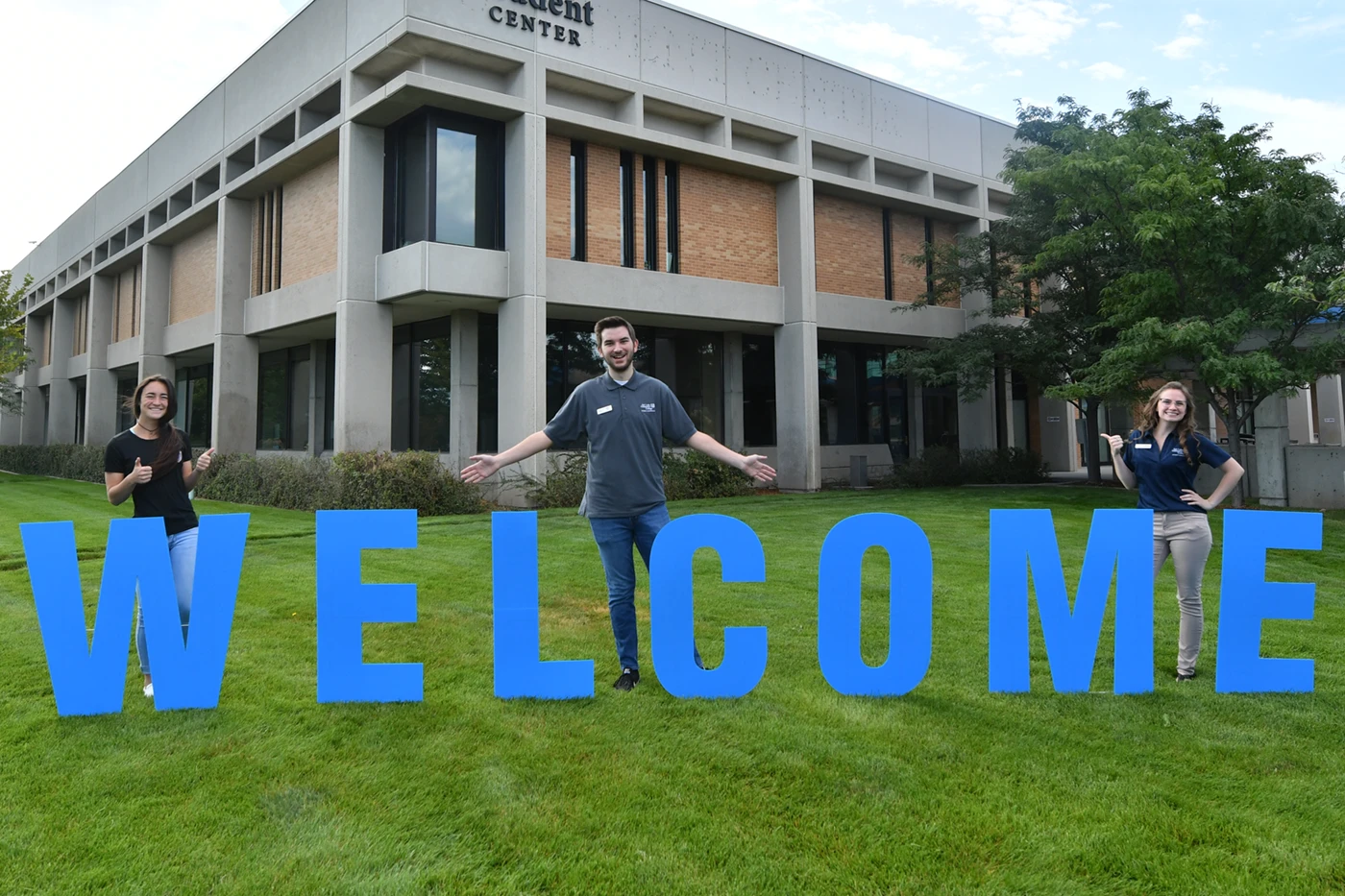 SLCC students stand in front of block letters spelling out "Welcome"