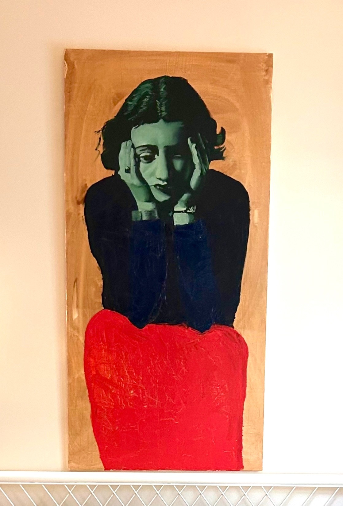 A painting of a woman looking down and holding her hands to her temples in pain or discomfort. The woman’s face and hands are depicted in a green monochrome palette. Her clothing is a black long-sleeved top and a shapeless red skirt or pants. The background is roughly textured burnt umber.