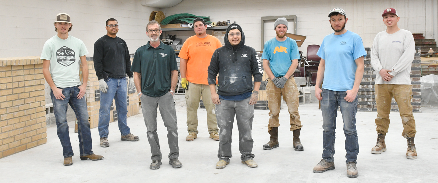a bunch of construction workers standing side by side