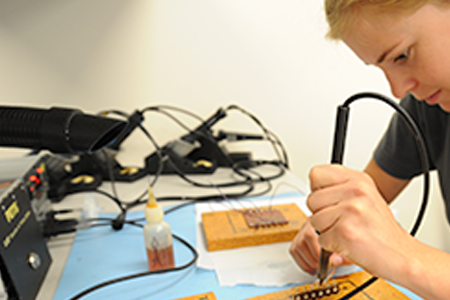 a woman working with microchips